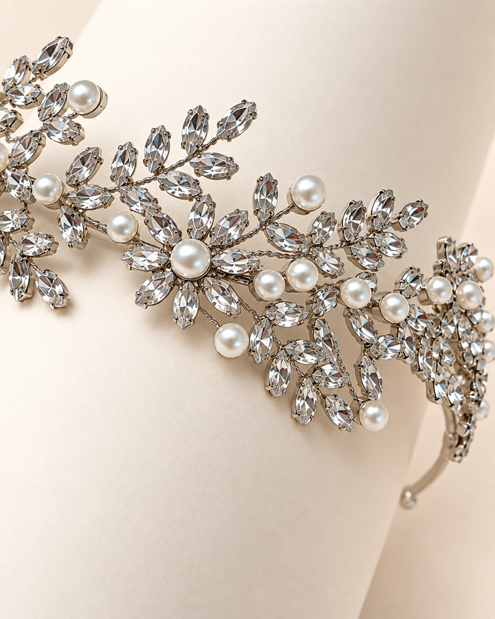 Close-up of marquise rhinestone leaves and ivory pearls on the Liora floral wedding headband