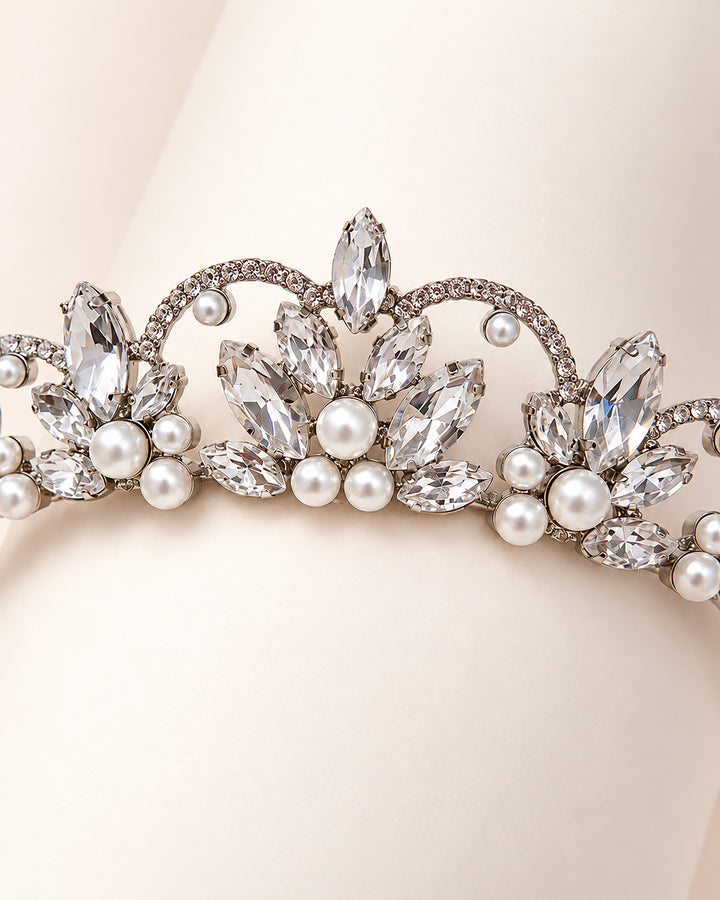 Detail of pearl clusters and marquise rhinestones on a scalloped silver bridal tiara