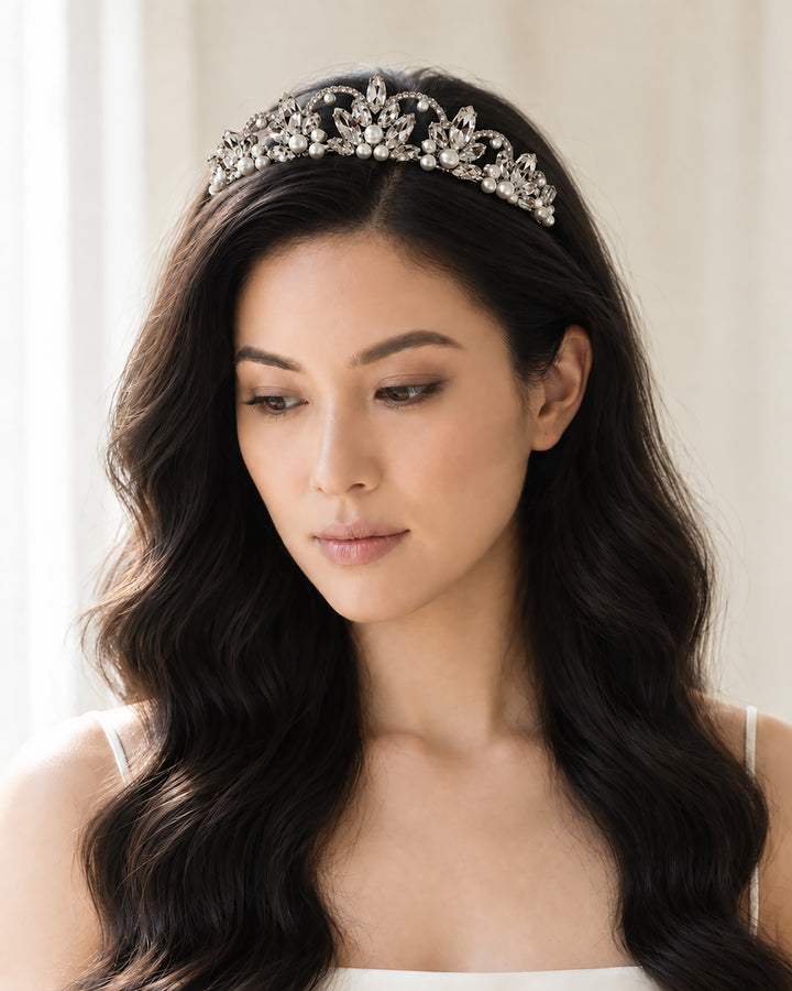 Bride with long waves wearing a silver scalloped crown tiara with marquise rhinestones and pearls
