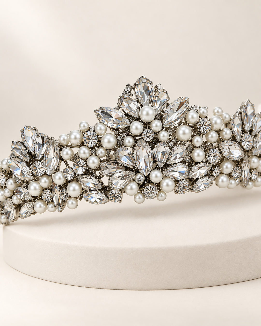 Silver bridal crown tiara with marquise rhinestones and pearls rising to a tall center peak