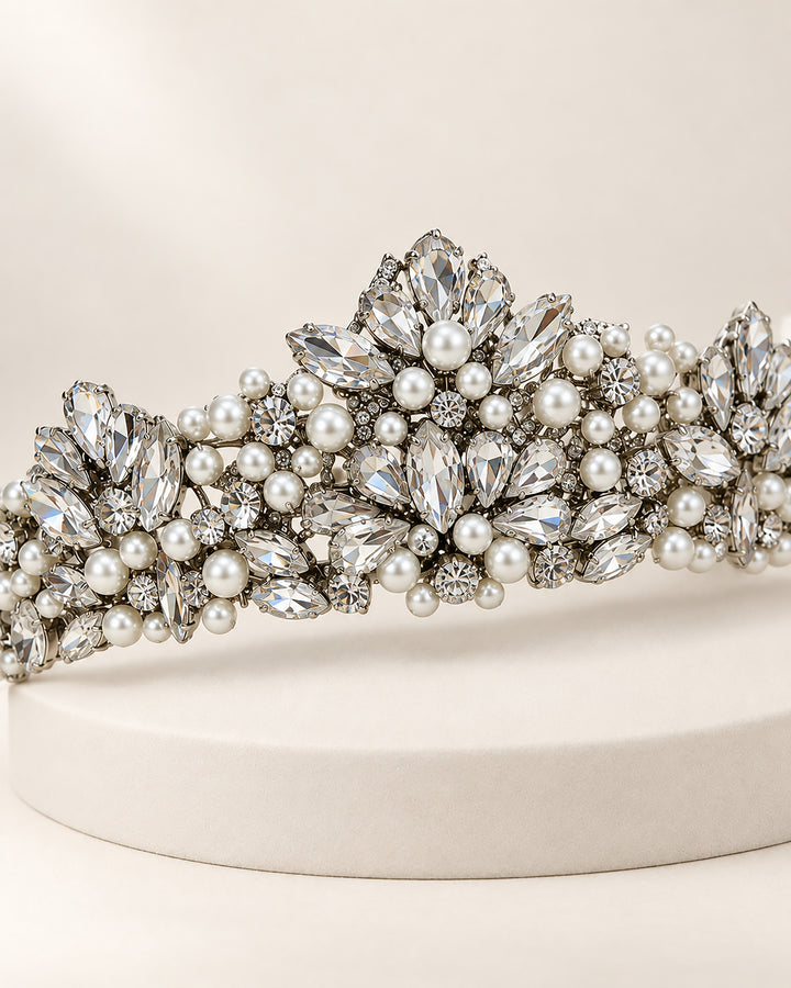 Silver bridal crown tiara with marquise rhinestones and pearls rising to a tall center peak