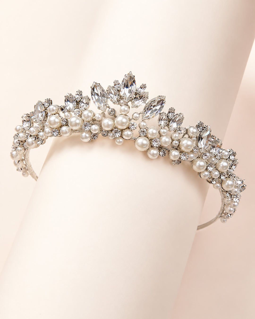 Silver wedding tiara with a pearl clustered center peak tapering into a thin rhinestone band