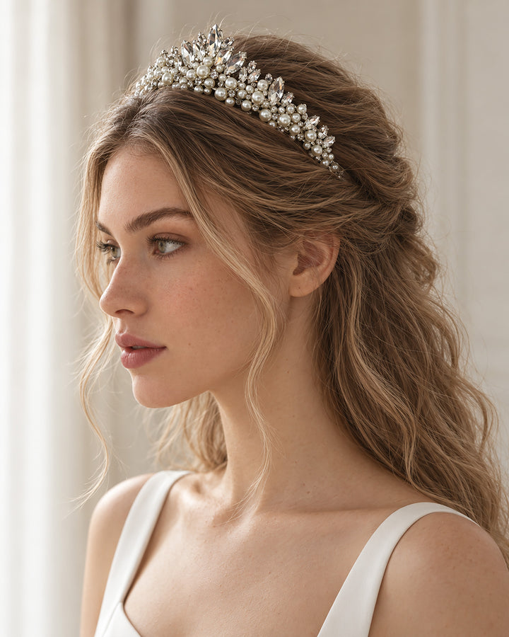 Bride with wavy hair pulled back wearing a silver crystal and pearl bridal tiara