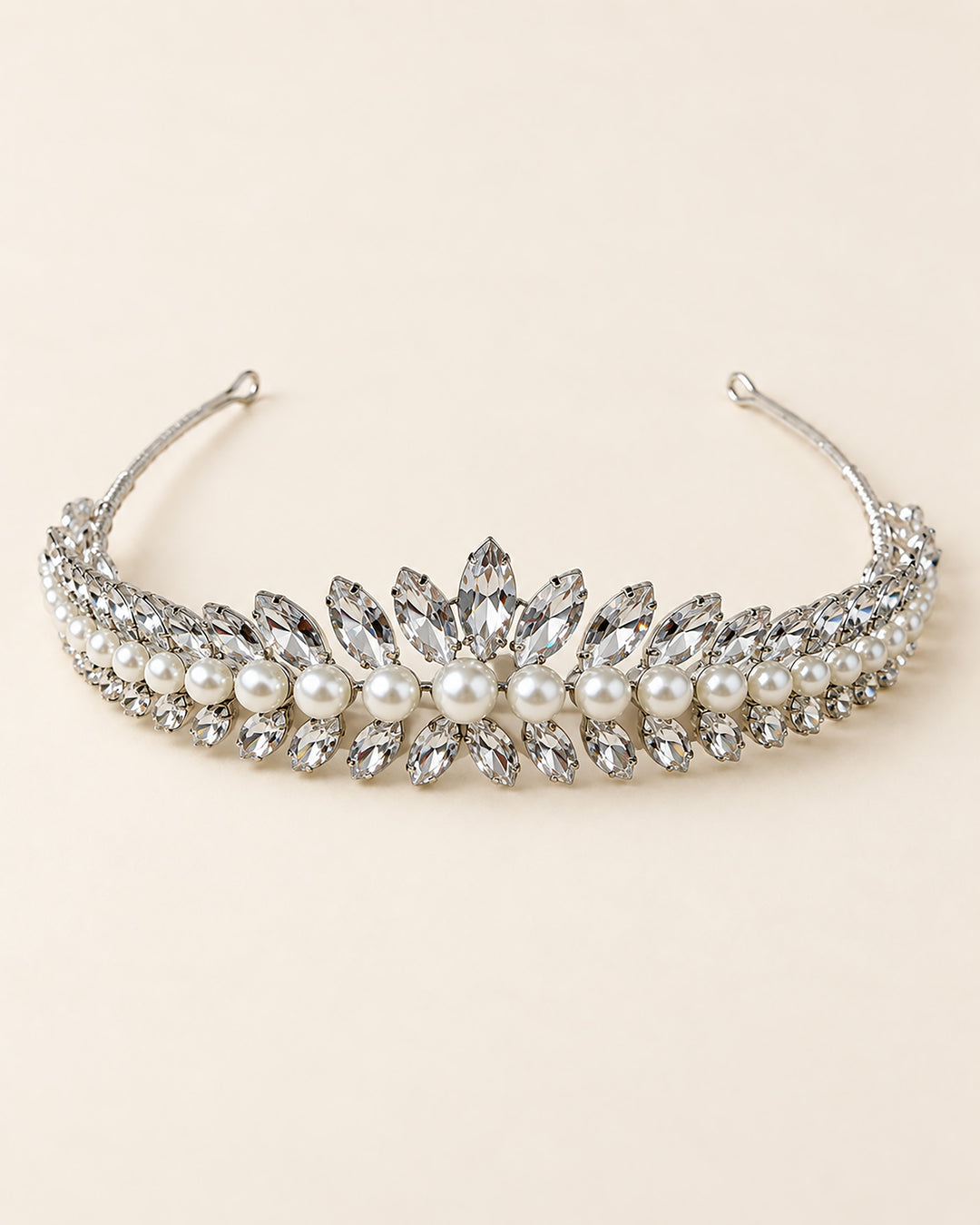 Full view of the Mavis wedding tiara, with a rhinestone and pearl center peak tapering to pin-loop ends