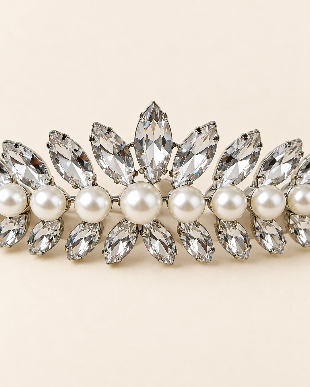 Close-up of marquise rhinestones framing a row of ivory pearls on the Mavis bridal crown