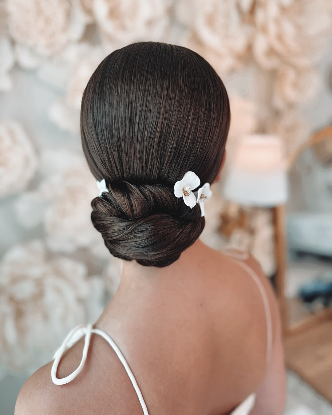 Bride wearing Dareth Colburn Hair Pins that are ivory clay flowers with beads