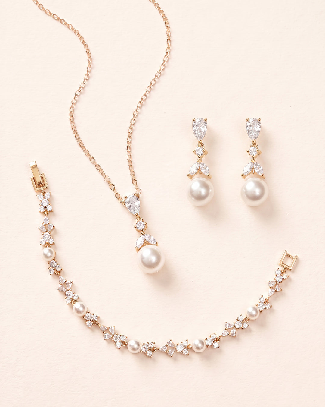 Gold Kelsey pearl pendant necklace, drop earrings and matching bracelet, a coordinated wedding jewelry set